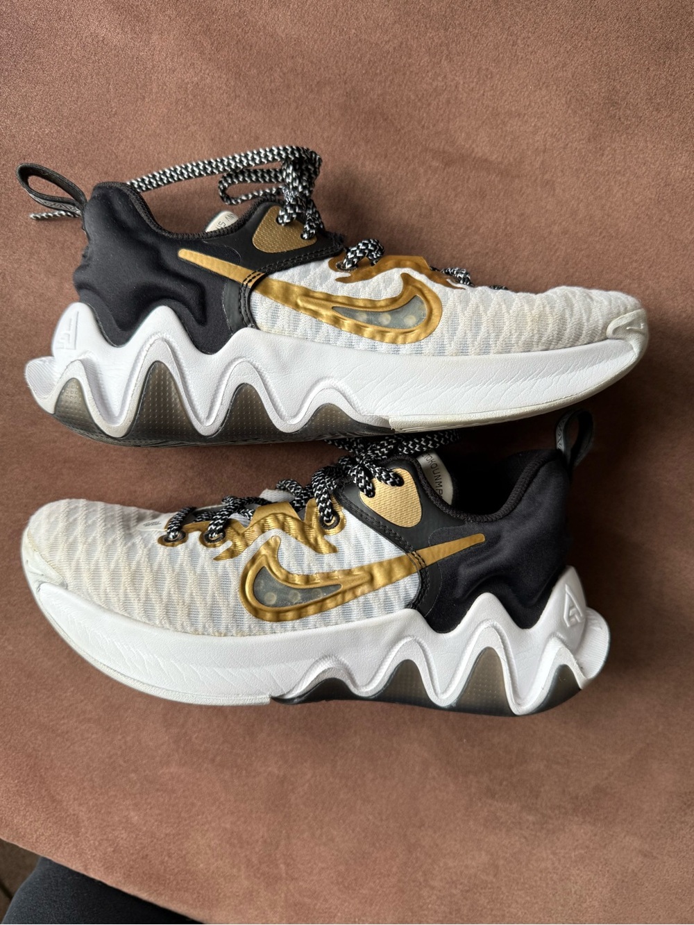 Nike Kids White Sneakers with Gold Swoosh and Black Accents